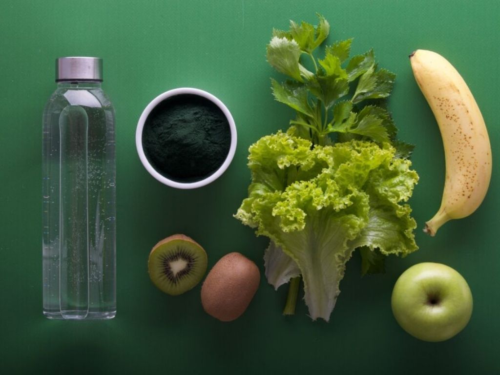 Water Bottle, Lettuce, Banana, Apple and Kiwi on green background