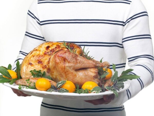 Garnished citrus glazed turkey on a platter ready to be served