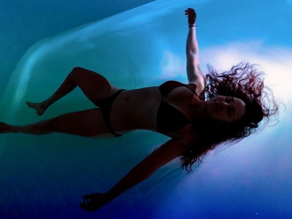 Woman laying in a float tank