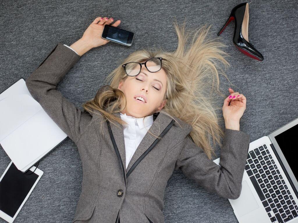 Woman laying on floor in overwhelm